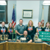 WESCLIN MIDDLE SCHOOL’S GIRLS basketball team on Monday made the latest stop on their district-wide tour of public bodies honoring their achievement of winning the Class L state bas- ketball tournament this past season. Here, the girls and their coaches pose with New Baden may- or Taylor Zurliene following the reading of a proclamation in their honor
